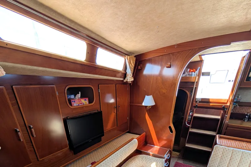 Iteration Yacht Photos Pics Interior of 1994 Amel 53 Super Maramu yacht with wood paneling and seating area.