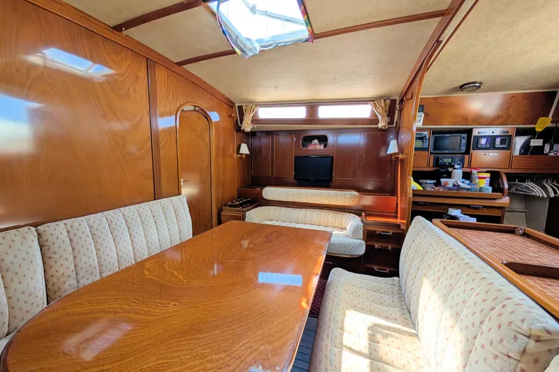 Iteration Yacht Photos Pics Luxurious interior of 1994 Amel 53 Super Maramu yacht with wood finish and seating.