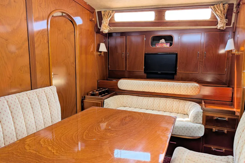 Iteration Yacht Photos Pics Luxurious interior of 1994 Amel 53 Super Maramu yacht with wood finish and cozy seating.