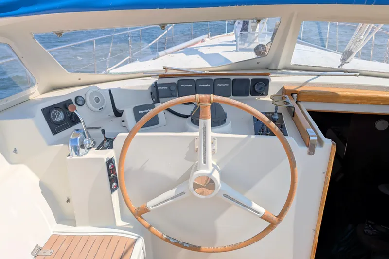 Iteration Yacht Photos Pics Cockpit of 1994 Amel 53 Super Maramu sailboat with steering wheel and navigation instruments.