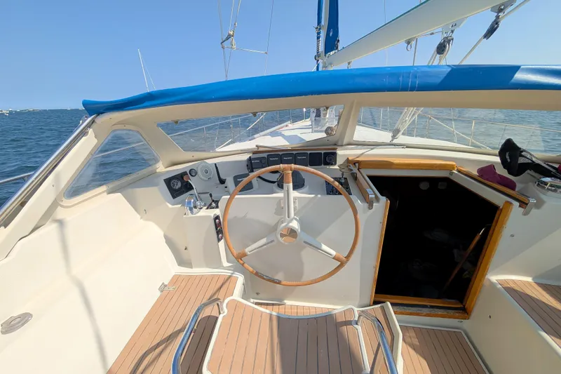 Iteration Yacht Photos Pics Cockpit of 1994 Amel 53 Super Maramu sailboat with wooden steering wheel.