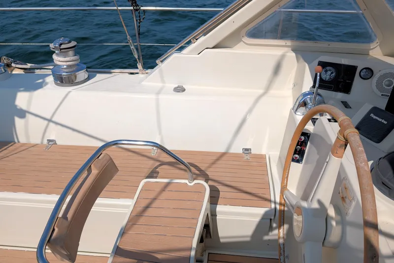 Iteration Yacht Photos Pics Cockpit of 1994 Amel 53 Super Maramu sailboat with wooden deck and steering wheel.