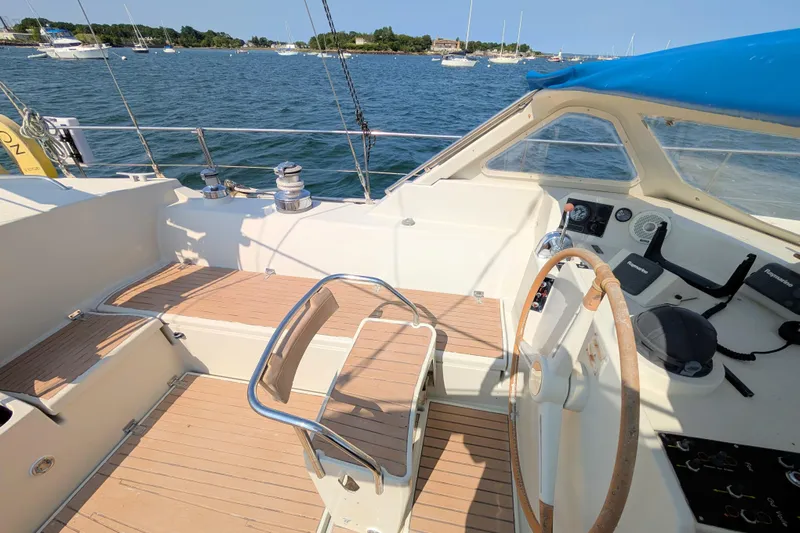 Iteration Yacht Photos Pics Cockpit of 1994 Amel 53 Super Maramu sailboat with steering wheel and navigation controls.