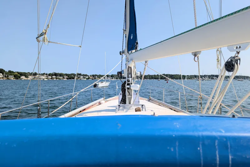 Iteration Yacht Photos Pics Sailing on a 1994 Amel 53 Super Maramu yacht, coastal view in the background.