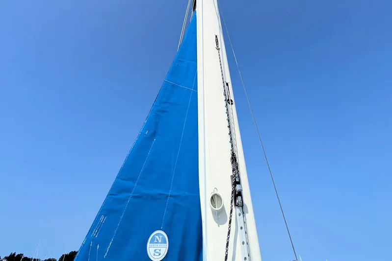 Iteration Yacht Photos Pics Blue sail of 1994 Amel 53 Super Maramu against clear sky.