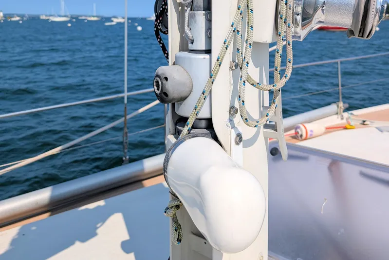 Iteration Yacht Photos Pics Close-up of 1994 Amel 53 Super Maramu sailboat mast with ropes and ocean background.