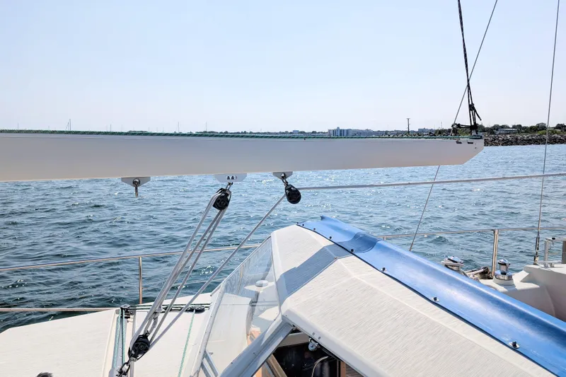 Iteration Yacht Photos Pics Sailing on a 1994 Amel 53 Super Maramu yacht, overlooking calm waters and distant shoreline.