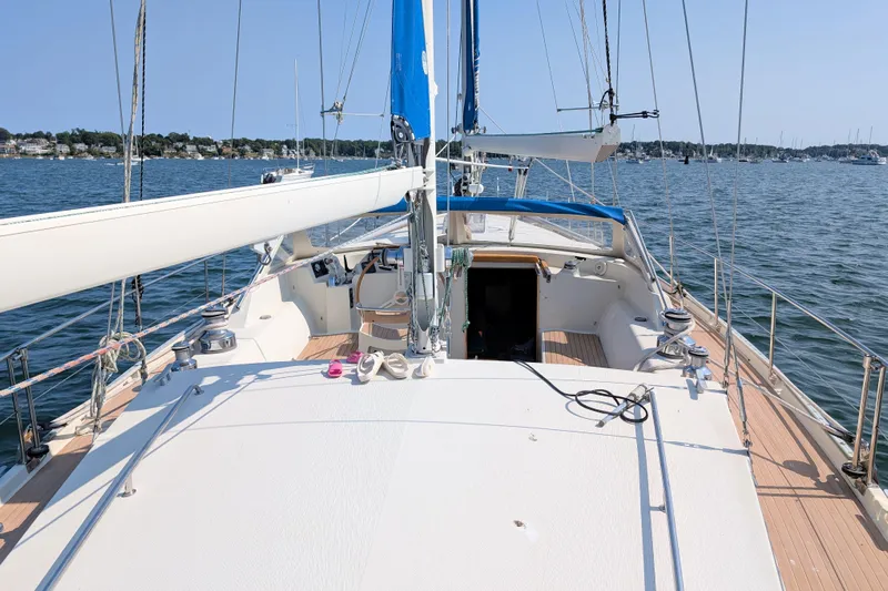 Iteration Yacht Photos Pics Sailing yacht Amel 53 Super Maramu 1994 on calm waters, showcasing deck and rigging.