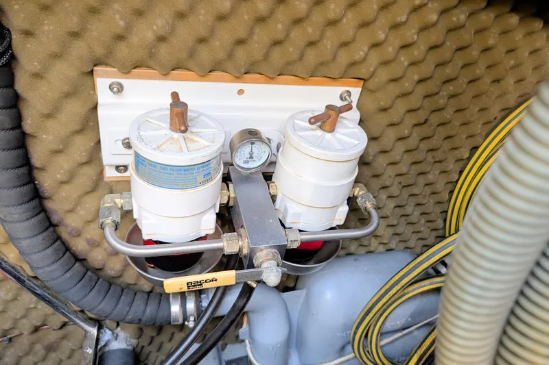 Iteration Yacht Photos Pics Engine compartment of 1994 Amel 53 Super Maramu with dual fuel filters and pressure gauge.