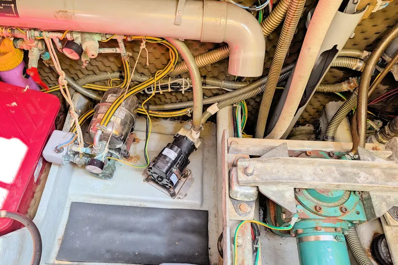 Iteration Yacht Photos Pics Engine room of a 1994 Amel 53 Super Maramu sailboat, showing mechanical components and wiring.