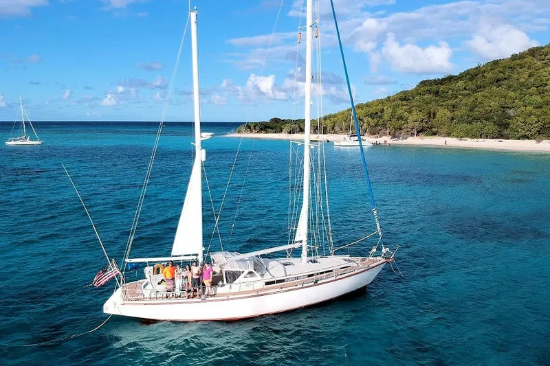 Iteration Yacht Photos Pics Sailing yacht Amel 53 Super Maramu 1998 near tropical island with clear blue waters.