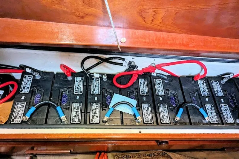 Iteration Yacht Photos Pics Battery compartment of a 1998 Amel 53 Super Maramu sailboat with connected cables.