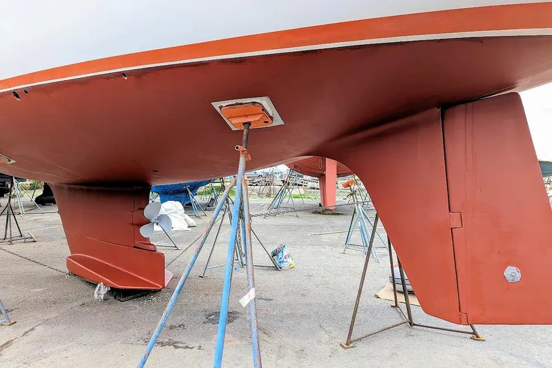 Iteration Yacht Photos Pics 1998 Amel 53 Super Maramu sailboat hull and keel on stands, showcasing underside details.