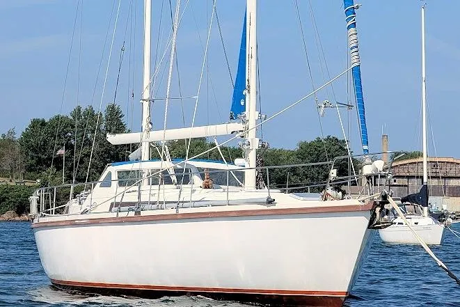 Iteration Yacht Photos Pics 1998 Amel 53 Super Maramu sailboat on water, featuring white hull and blue accents.