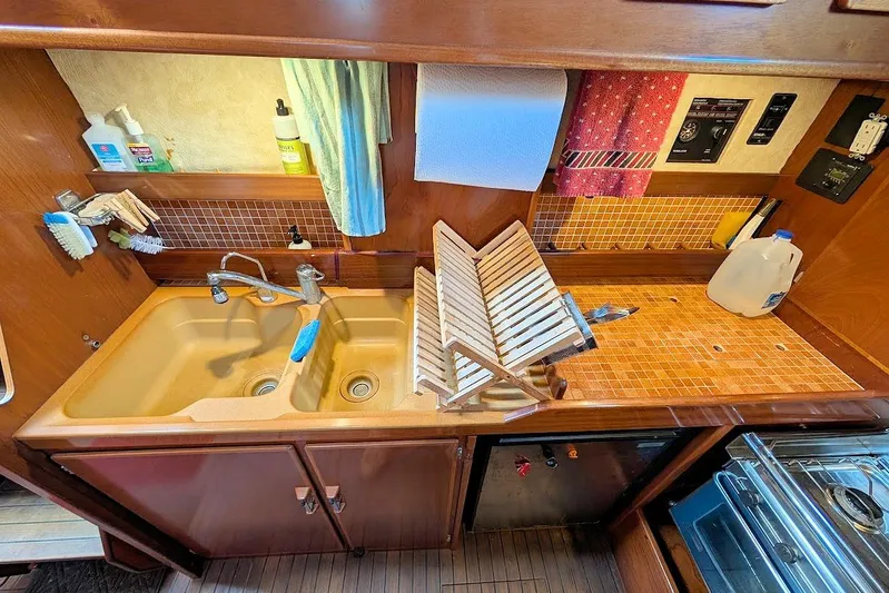 Iteration Yacht Photos Pics Galley kitchen of 1998 Amel 53 Super Maramu yacht with double sink and dish rack.