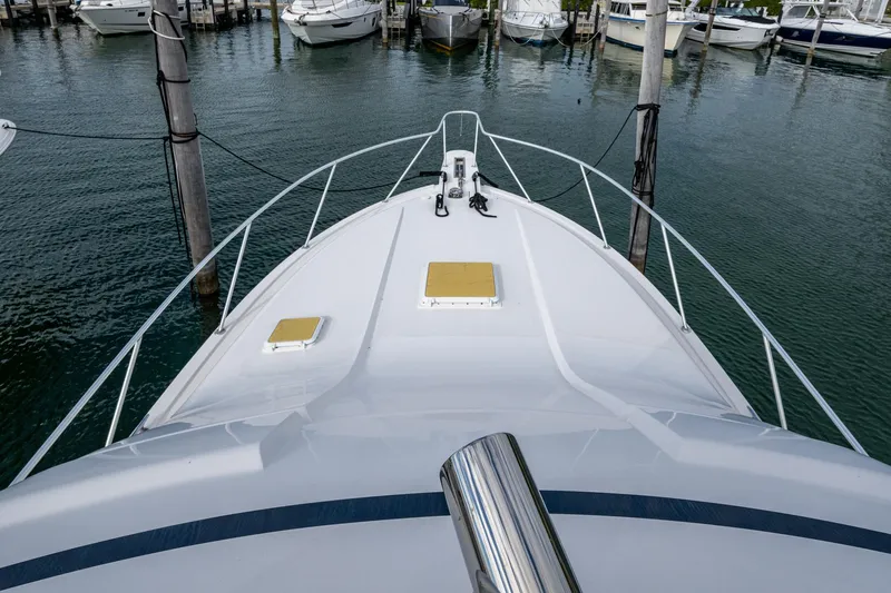 Vet Billz Yacht Photos Pics Bow view of 2001 Bertram 390 yacht docked in a marina.