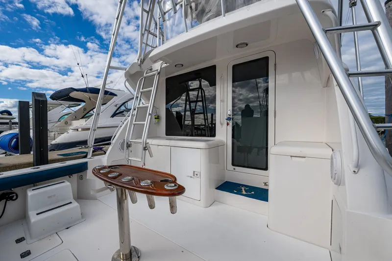 Vet Billz Yacht Photos Pics 2001 Bertram 390 yacht deck with ladder, rod holders, and marina view.