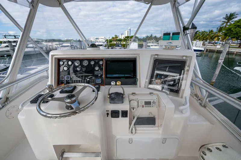 Vet Billz Yacht Photos Pics Cockpit of 2001 Bertram 390 yacht with steering wheel and navigation instruments.
