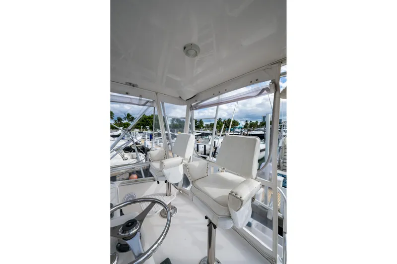 Vet Billz Yacht Photos Pics Interior view of 2001 Bertram 390 yacht with white captain's chairs and steering wheel.