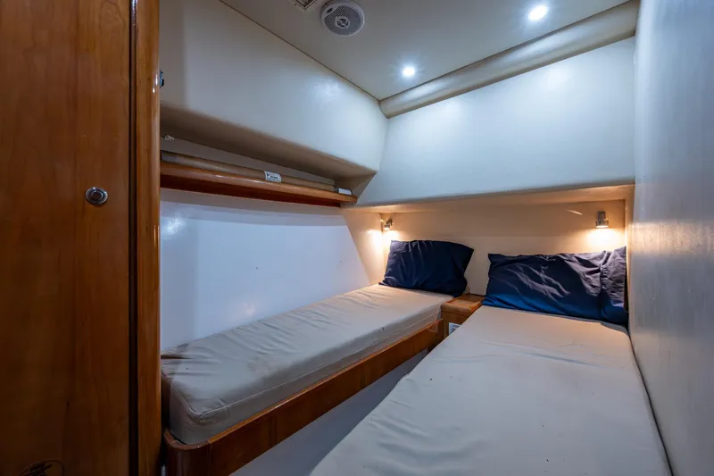 Vet Billz Yacht Photos Pics 2001 Bertram 390 cabin interior with twin beds and ambient lighting.