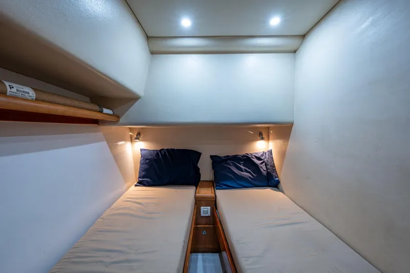 Vet Billz Yacht Photos Pics 2001 Bertram 390 cabin interior with twin beds and soft lighting.