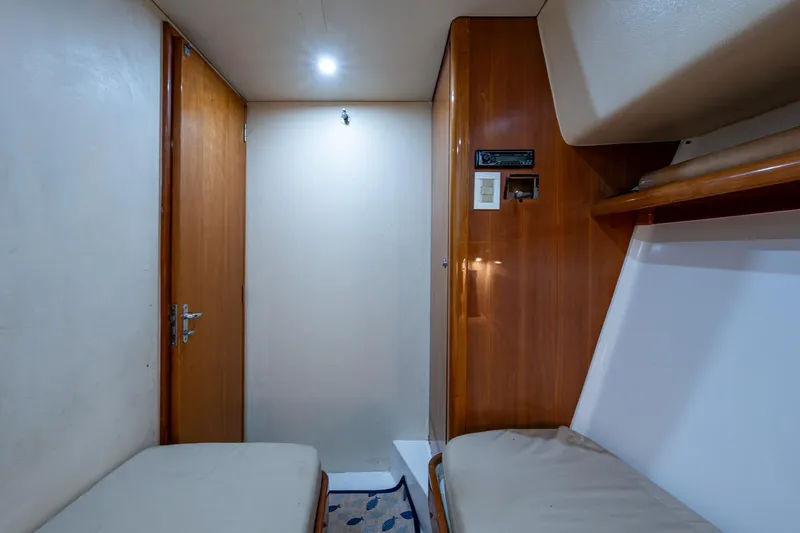 Vet Billz Yacht Photos Pics Interior cabin of 2001 Bertram 390 yacht with wooden paneling and seating.