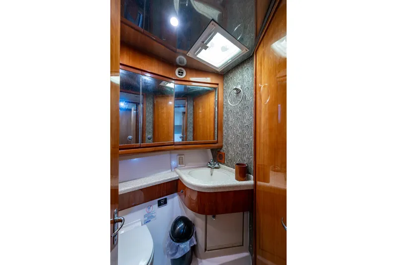 Vet Billz Yacht Photos Pics Luxurious bathroom interior of 2001 Bertram 390 yacht with wood accents and modern fixtures.