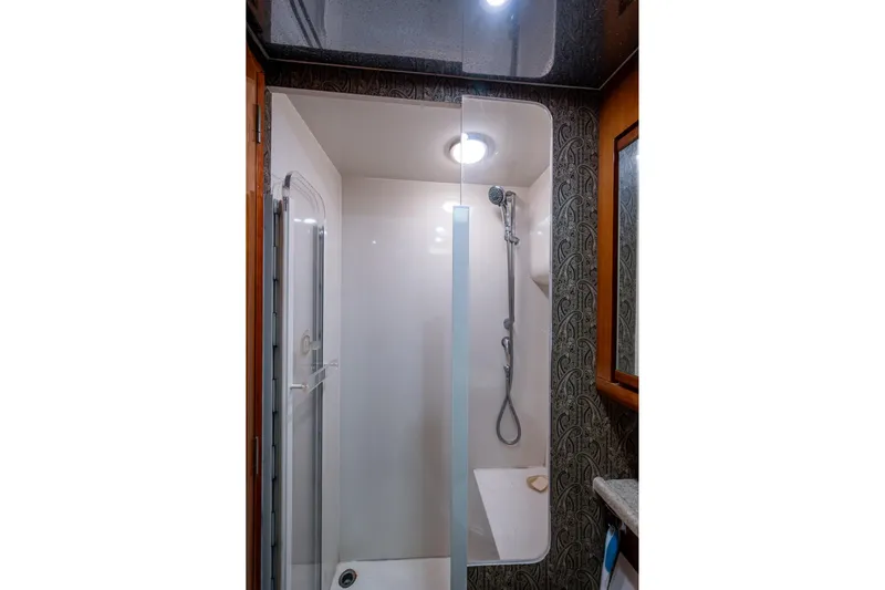 Vet Billz Yacht Photos Pics Shower area in a 2001 Bertram 390 yacht, featuring modern fixtures and elegant design.