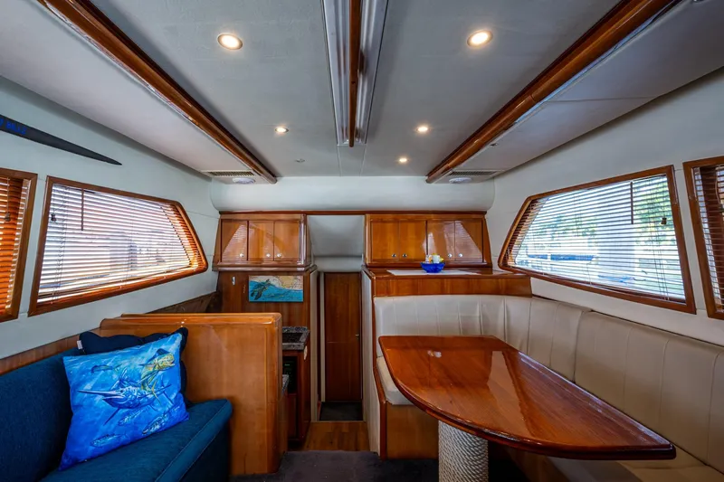 Vet Billz Yacht Photos Pics Interior of a 2001 Bertram 390 yacht with wood accents and plush seating.
