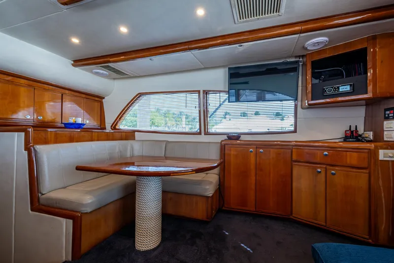 Vet Billz Yacht Photos Pics Luxurious interior of a 2001 Bertram 390 yacht with wooden cabinetry and plush seating.