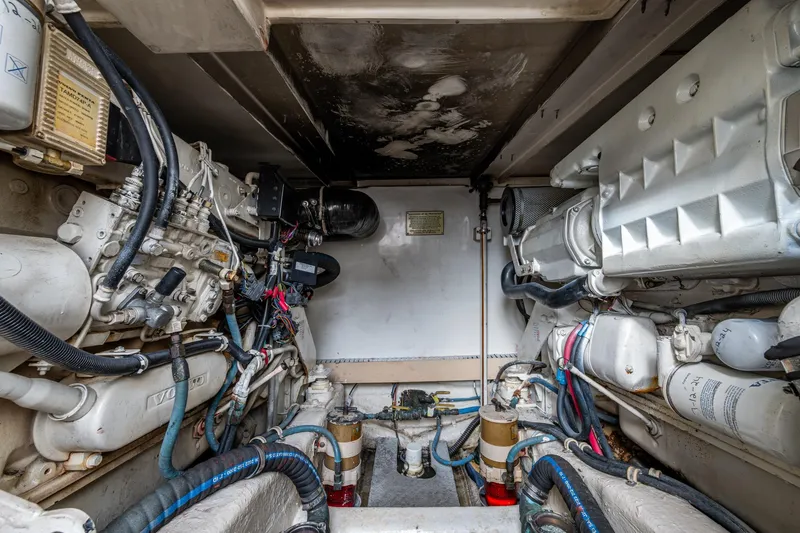 Vet Billz Yacht Photos Pics Engine room of a 2001 Bertram 390 boat, showcasing complex machinery and wiring.