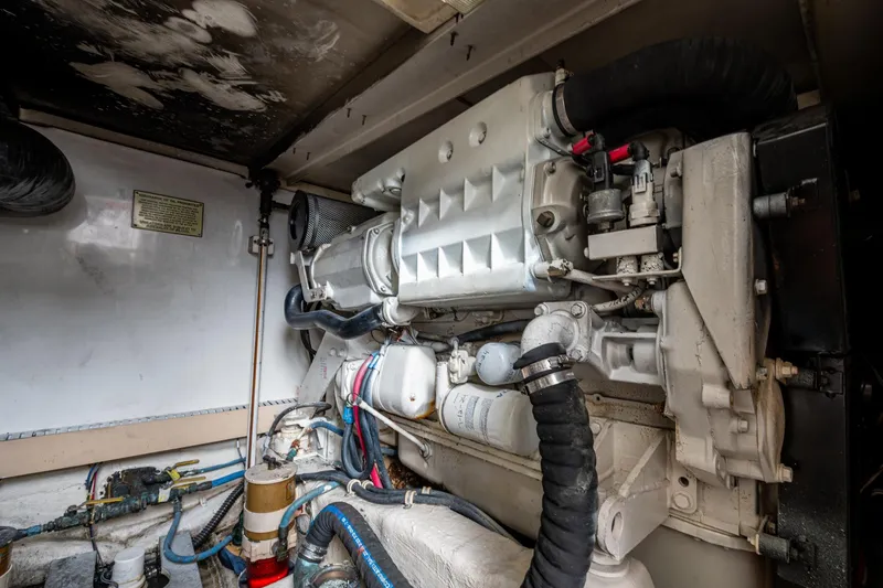 Vet Billz Yacht Photos Pics Engine compartment of a 2001 Bertram 390 boat, showcasing detailed mechanical components.