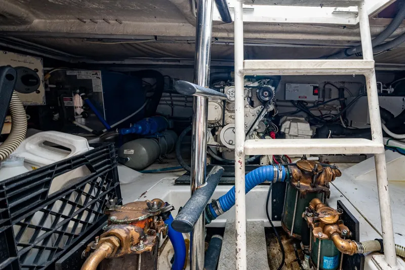 Vet Billz Yacht Photos Pics Engine room of a 2001 Bertram 390 boat with visible machinery and ladder.
