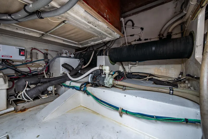 Vet Billz Yacht Photos Pics Engine room of a 2001 Bertram 390 boat with visible wiring and machinery.