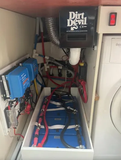  Yacht Photos Pics Electrical setup with batteries, wiring, and Dirt Devil vacuum in a compact space.
