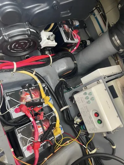  Yacht Photos Pics Engine compartment of a 2016 Carver C43 Coupe with visible wiring and battery setup.