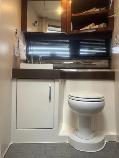  Yacht Photos Pics Modern bathroom interior in a 2016 Carver C43 Coupe yacht, featuring a sink and toilet.