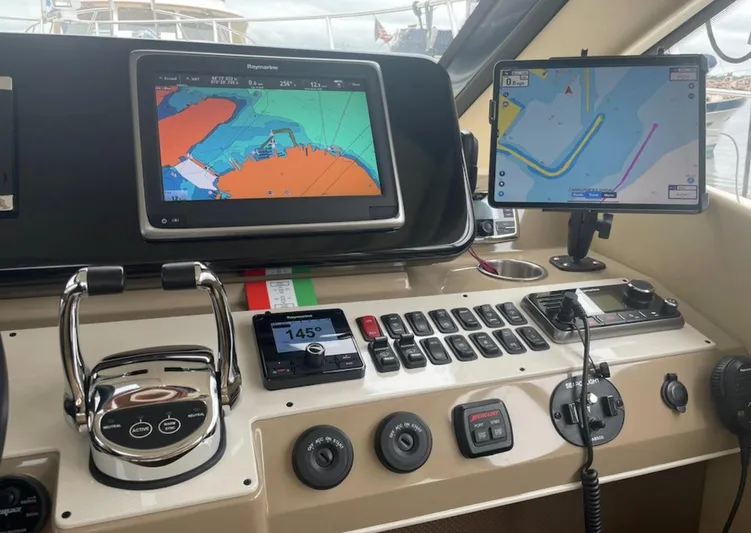  Yacht Photos Pics Control panel of a 2016 Carver C43 Coupe with navigation screens and controls.