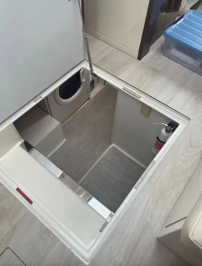  Yacht Photos Pics Hatch opening in a 2016 Carver C43 Coupe, revealing storage space and fire extinguisher.