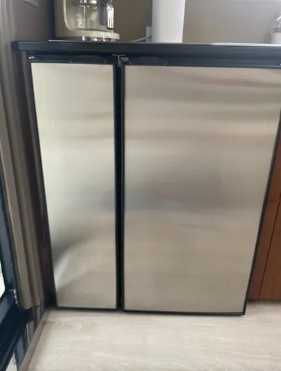  Yacht Photos Pics Stainless steel double-door refrigerator in a modern kitchen setting.