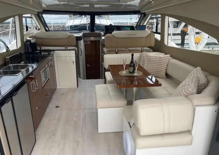  Yacht Photos Pics Luxurious interior of a 2016 Carver C43 Coupe yacht with elegant seating and dining area.
