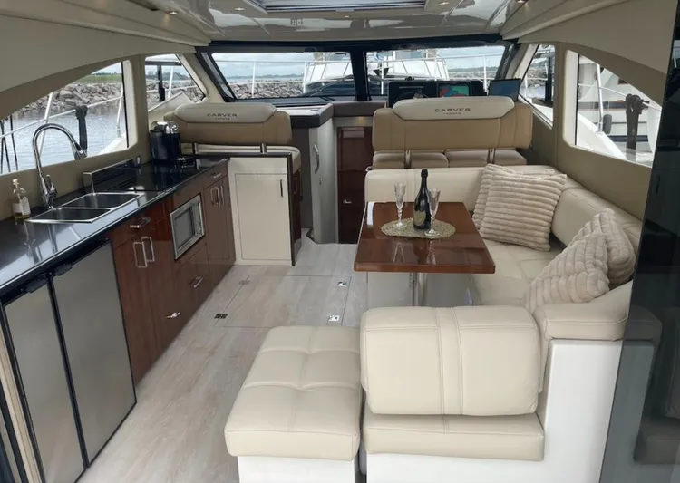  Yacht Photos Pics Luxurious interior of a 2016 Carver C43 Coupe yacht with modern kitchen and seating area.
