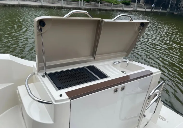  Yacht Photos Pics Outdoor grill and sink on a 2016 Carver C43 Coupe boat by the water.