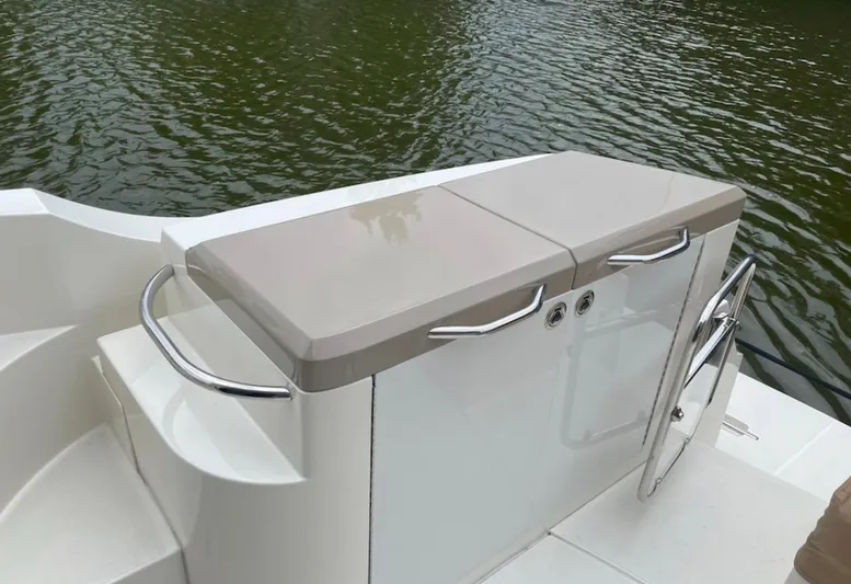  Yacht Photos Pics 2016 Carver C43 Coupe boat deck with storage compartment by the water.