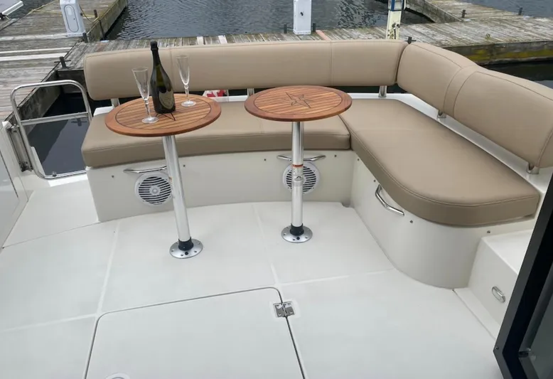  Yacht Photos Pics Luxurious seating area on a 2016 Carver C43 Coupe yacht with tables and champagne.