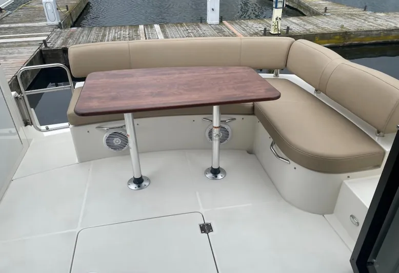  Yacht Photos Pics 2016 Carver C43 Coupe boat deck with beige seating and wooden table.