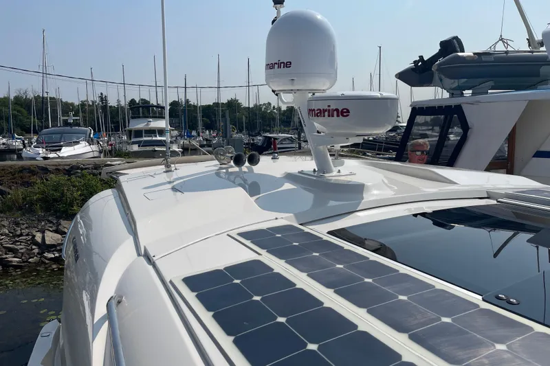  Yacht Photos Pics 2016 Carver C43 Coupe yacht with solar panels docked at a marina.