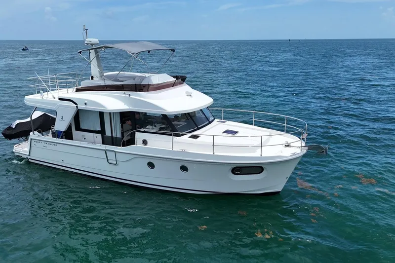  Yacht Photos Pics 2021 Beneteau Swift Trawler 41 Fly cruising on open sea under clear skies.
