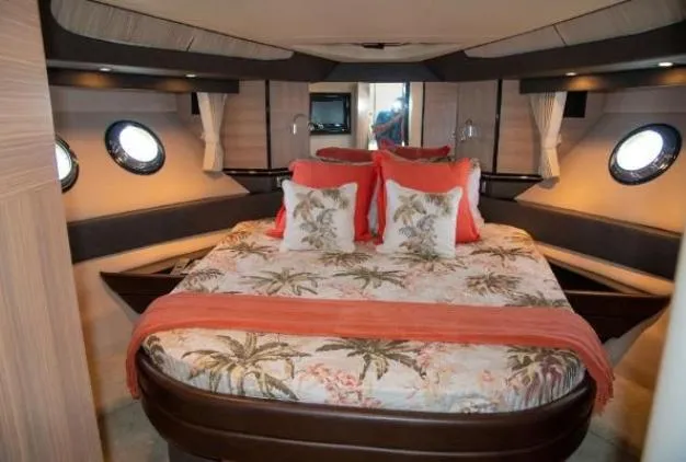 Why Knot Yacht Photos Pics Luxurious 2011 Marquis Sport Coupe bedroom with tropical-themed bedding and elegant porthole windows.
