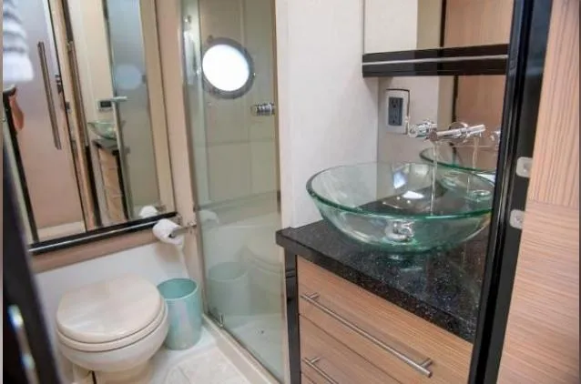 Why Knot Yacht Photos Pics Luxurious bathroom in 2011 Marquis Sport Coupe with glass sink and modern fixtures.